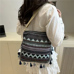 Ethnic style woven shoulder bag with chic tassels and retro geometric pattern for daily fashion.