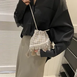 Woven bucket bag with fringe tassels, stylish crossbody shoulder bag for women daily fashion.