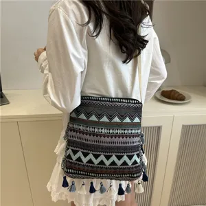 Ethnic style fringe shoulder bag with geometric embroidery and tassels for women fashion.