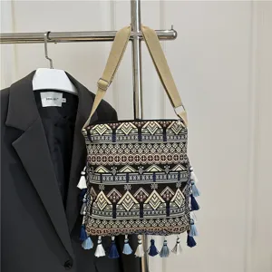 Detailed view of bohemian ethnic woven shoulder bag with geometric patterns and fringe tassels.