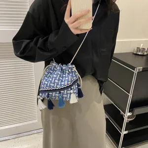 Woven fringe bucket bag for women, stylish shoulder crossbody bag with tassel decor.