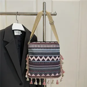 Ethnic style canvas shoulder bag with colorful tassels, geometric pattern handbag for women.