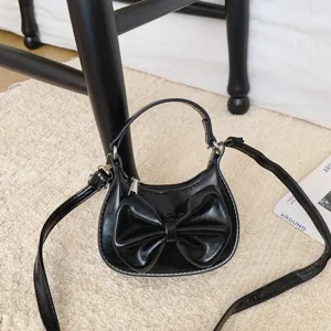 Cute black mini shoulder bag for kids with stylish bow, perfect patent leather handbag.