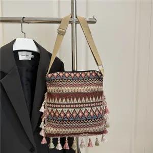 Ethnic style woven shoulder bag with geometric pattern and tassels for women daily retro use.
