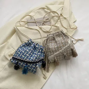 Woven bucket bag with tassels, stylish fringe crossbody bag for women, ethnic shoulder bag.
