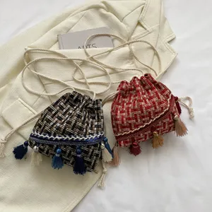 Ethnic tweed bucket bag detail showing intricate fringes, woven patterns, and design.