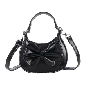 Kids black mini handbag with cute bow, stylish single shoulder messenger bag for girls.