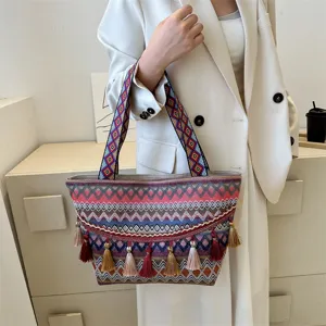 Boho ethnic tote bag with wide strap and tassels, spacious canvas shoulder bag for women.
