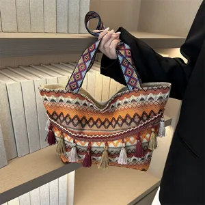 Close-up view of the woven tote bag detail, showcasing geometric patterns and elegant tassels.