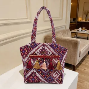 Ethnic style woven tote bag with colorful geometric patterns and tassels for women daily use.