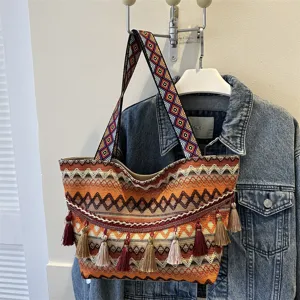 Boho woven tote bag for women with ethnic wide strap and tassel charms, large capacity.
