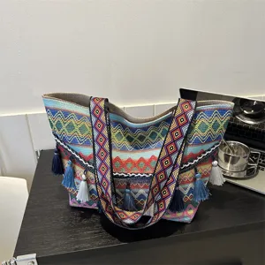 Woven tote bag for women, ethnic geometric wide strap shoulder bag with cute colorful tassels.
