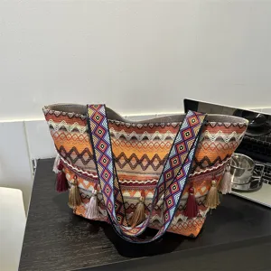 Ethnic woven tote bag for women with wide strap and tassels, large capacity daily shoulder bag.