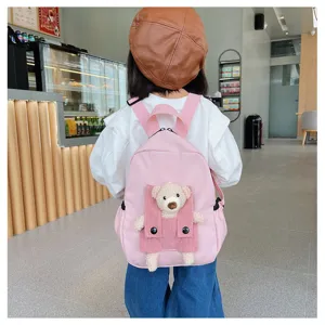 Pink cartoon bear plush pocket kids backpack detail, lightweight casual school bag for kids.