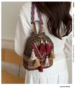 Boho ethnic style mini backpack detail shot showing exquisite tassel pendants and geometric straps.