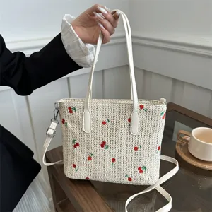 Summer woven tote bag with cute cherry embroidery, white handles and large capacity design.