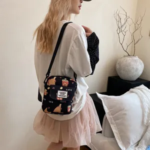 Canvas crossbody bag with cute capybara print, casual shoulder bag for women and students.