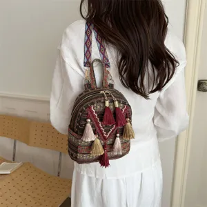 Boho ethnic backpack tassel detail, woven mini bag close up view for casual daily fashion.