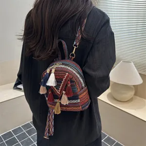Ethnic style women mini backpack with colorful tassels, casual versatile design for daily use.