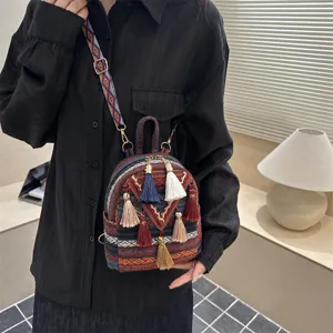 Ethnic style mini backpack for women, casual versatile tassel crossbody bag with vibrant woven strap.