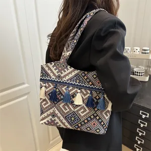 Ethnic style woven embroidered shoulder bag with tassel details and geometric patterns view