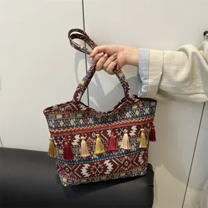 Retro woven ethnic style handbag with colorful tassels, large capacity commuter shoulder bag.