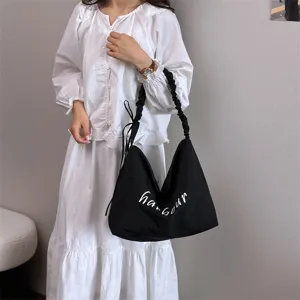 Black casual shoulder bag with letter print, large capacity canvas tote for women daily work.
