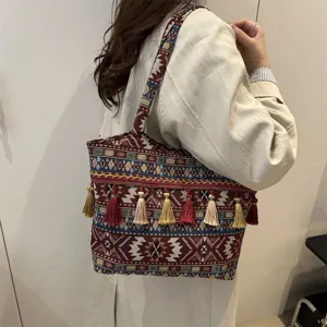 Retro ethnic style woven shoulder bag with colorful tassels and large capacity for women.