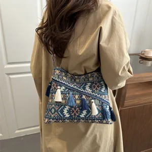Ethnic style canvas shoulder bag with geometric patterns and tassels for women's casual wear.
