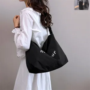 Casual black shoulder tote bag with slouchy design and white letter print for women daily commute.