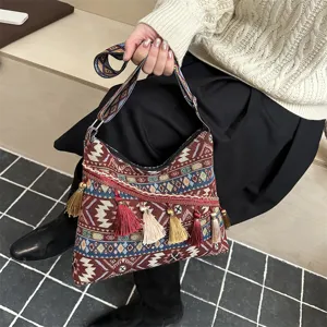 Ethnic woven shoulder bag detail showcasing intricate geometric patterns and decorative tassels.