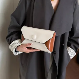 Color-blocked envelope clutch bag detail view, elegant minimalist women handbag.