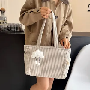 Corduroy tote bag for women, large capacity shoulder handbag with cute plush cloud pendant detail.