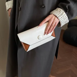 Elegant white and brown color block clutch bag, perfect for evening parties and stylish events.