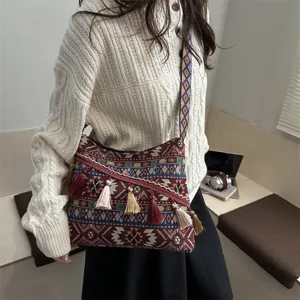 Ethnic retro shoulder bag for women, casual woven crossbody bag with tassels and wide strap.