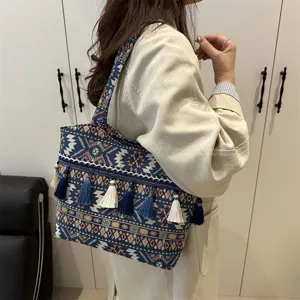 Ethnic style woven tote bag with tassels, vintage large capacity shoulder and underarm bag.