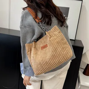 Corduroy shoulder bag for women, large winter underarm tote with chain strap and chic design.