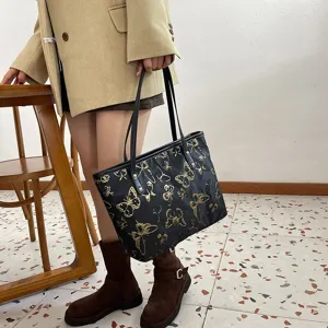 Black shoulder tote bag with gold butterfly jacquard for casual daily office commute.