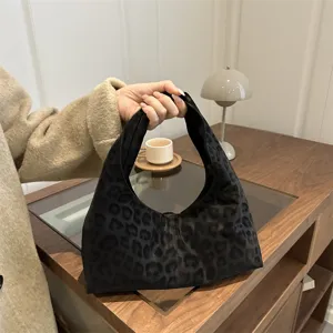 Leopard print hobo handbag detailed shot, stylish casual armpit bag showcasing unique texture.