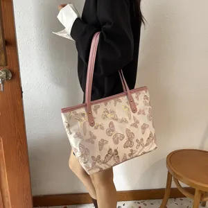 Detail shot of the stylish women tote bag featuring elegant pink butterfly jacquard pattern.