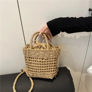 Woven straw bucket bag with drawstring inner pouch, chic shoulder crossbody handbag for summer.