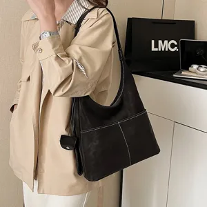 Stylish black slouchy shoulder bag with contrast stitching and large capacity for women.