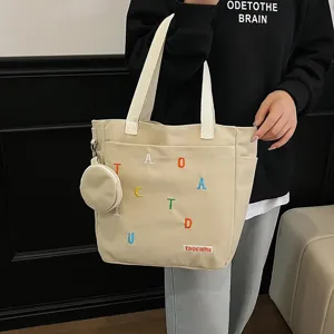 Canvas tote bag for women, large capacity shoulder bag with small pouch and chic design.