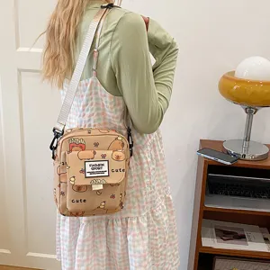 Cute capybara print canvas crossbody bag detail showing front pocket and adjustable strap.