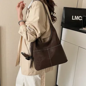 Detailed view of the retro brown suede tote bag, featuring contrast stitching and large capacity.