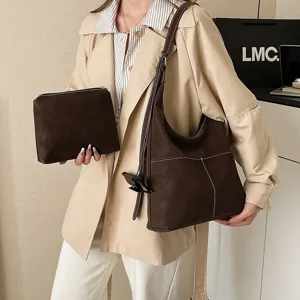Detail view of the vintage brown suede hobo shoulder bag with matching pouch and stitching.