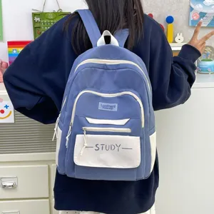 Detail view of stylish blue waterproof student casual backpack with multiple compartments.