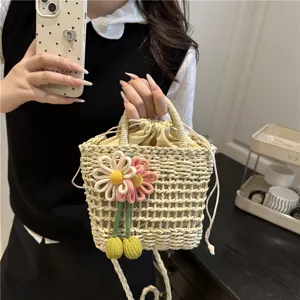 Close-up of woven bucket bag with handmade flower pendant, stylish summer casual accessory.