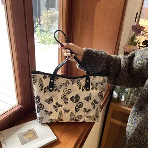 Casual women large capacity tote bag with butterfly jacquard pattern shoulder handbag detail view.