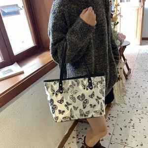Detail shot of women casual large capacity shoulder tote bag with cute butterfly jacquard fabric.